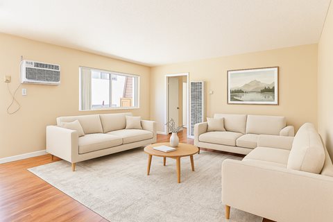 A living room with two couches, a coffee table, and a painting on the wall.